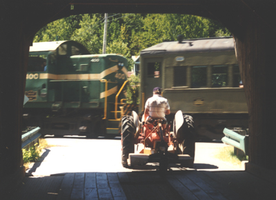 Tractor in covered bridge waiting for train